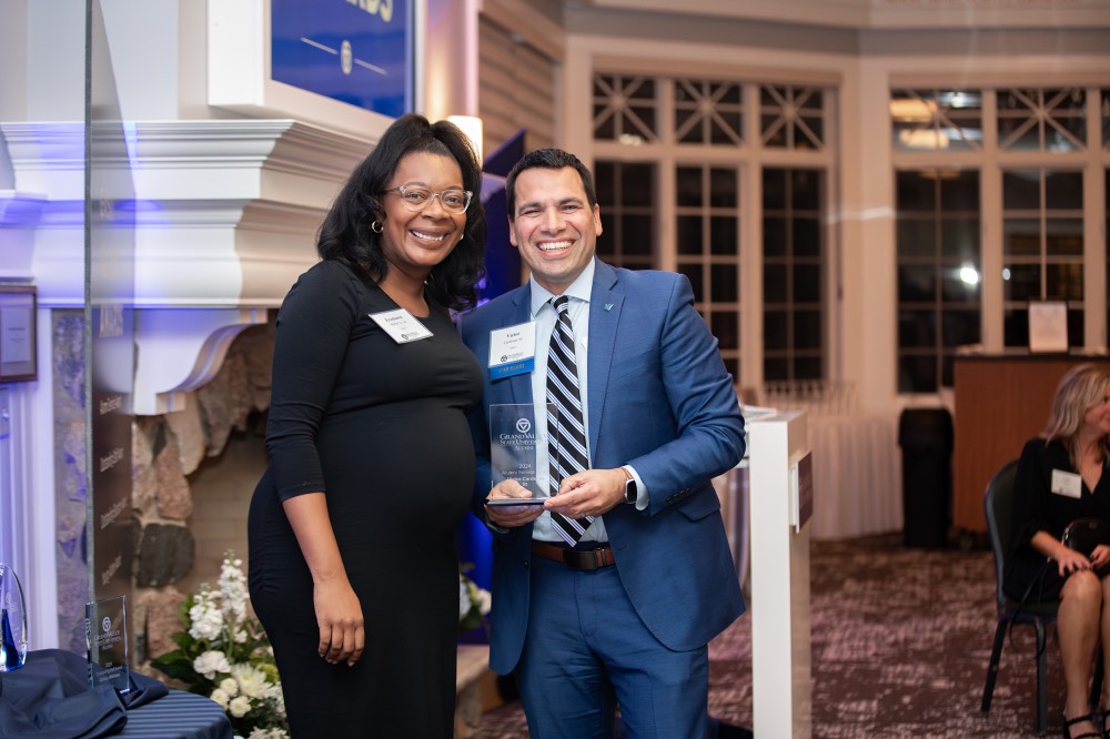 Victor Cardenas smiling with woman who introduced his award